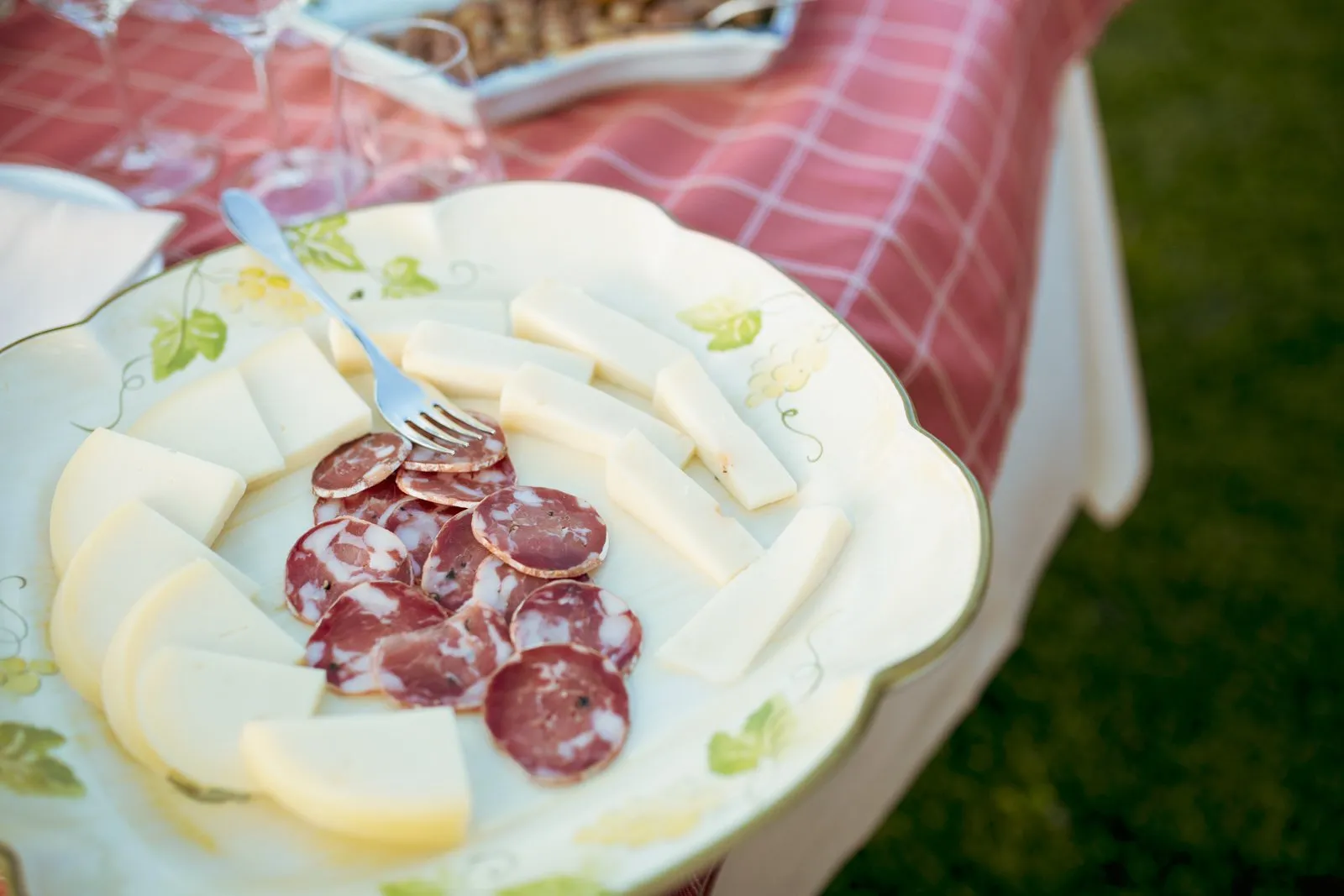 A platter of Sicilian cheeses and sliced salami served with the whites