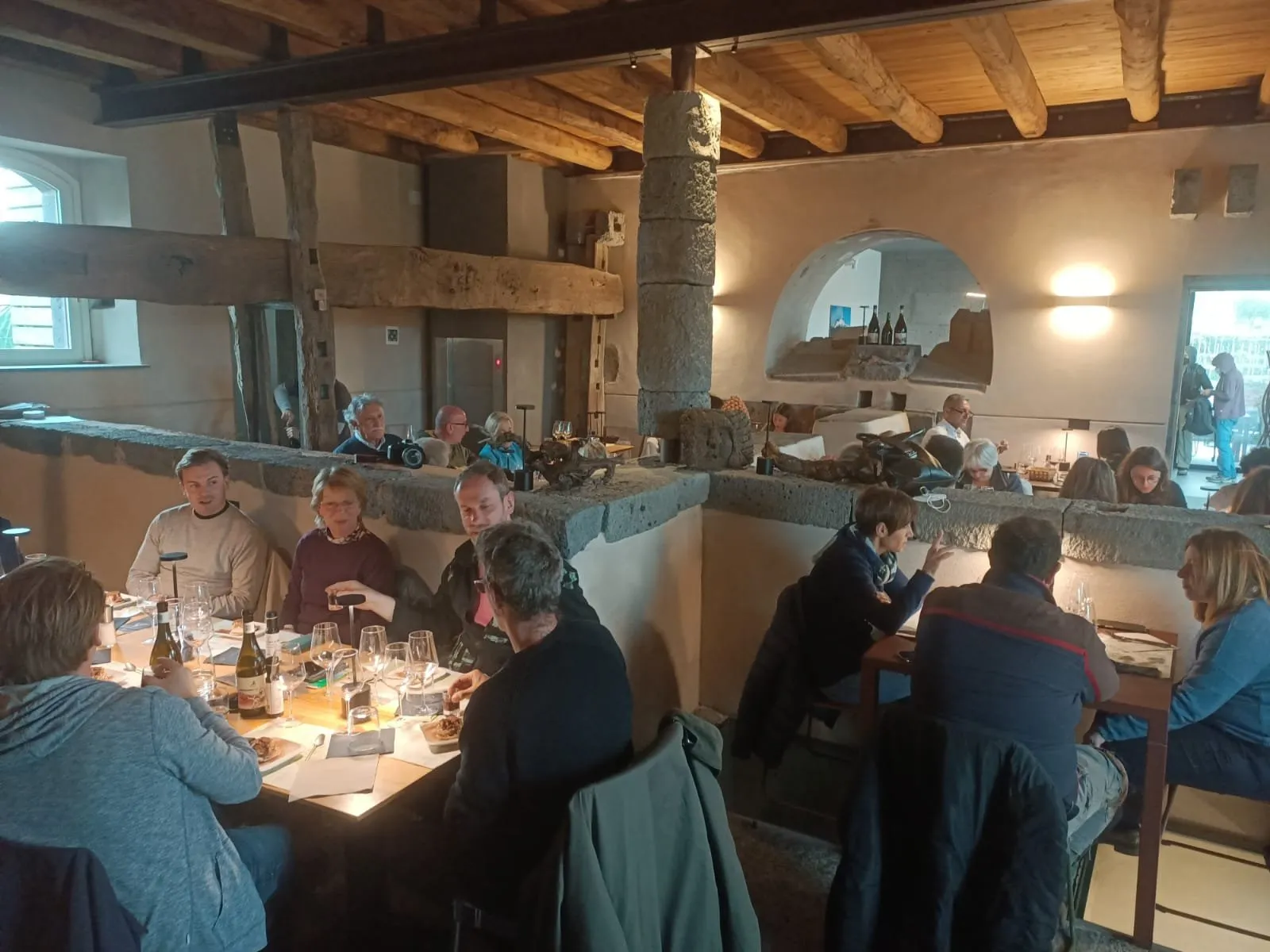 Guests seated at a long table in the second winery's tasting room