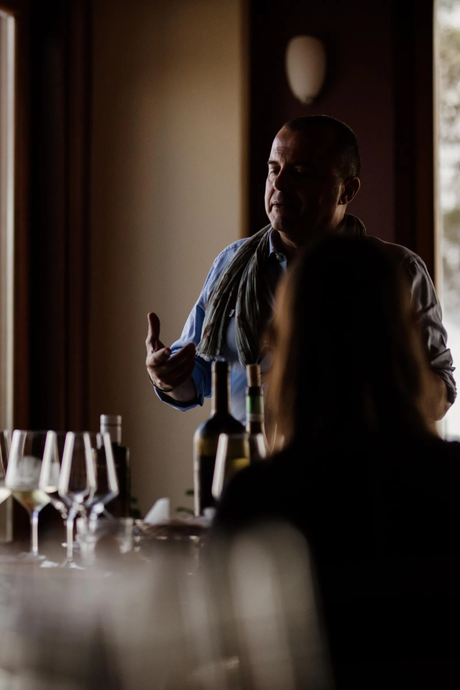 The sommelier setting out the flight in the low-lit tasting room