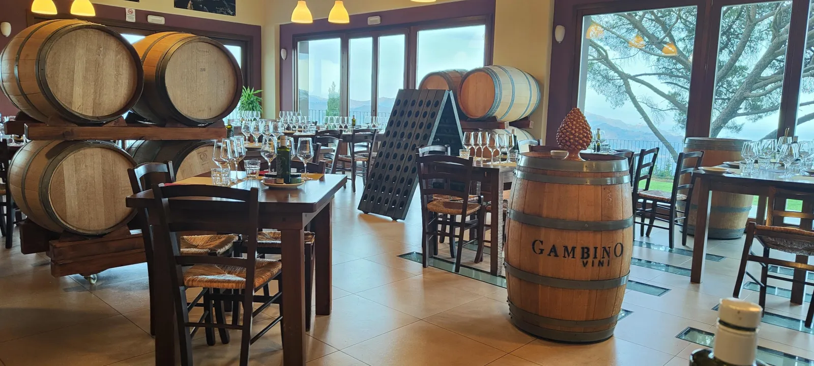The Gambino tasting room on Etna's north slope, barrels stacked along the far wall