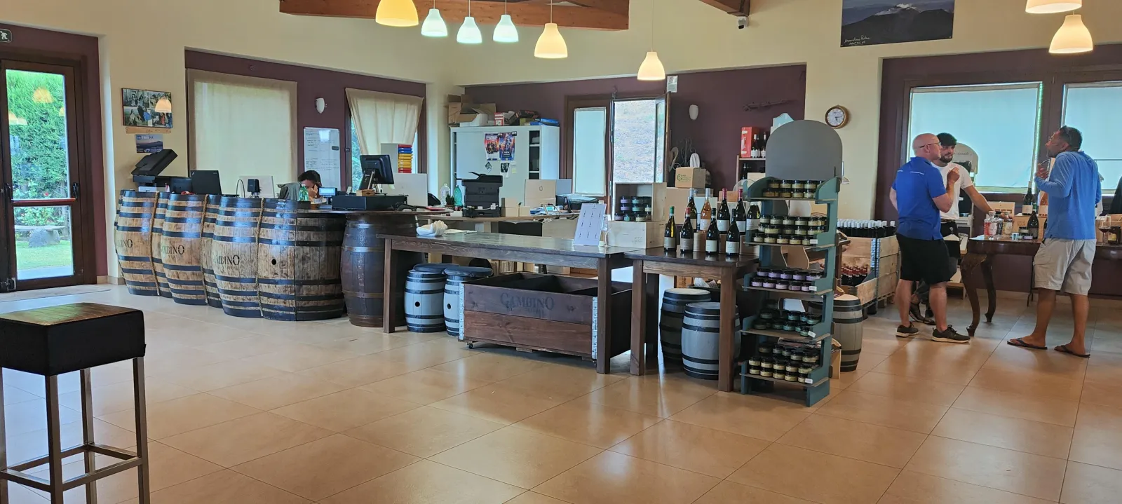 Visitors at the long tasting counter with the estate's current bottles ranged behind